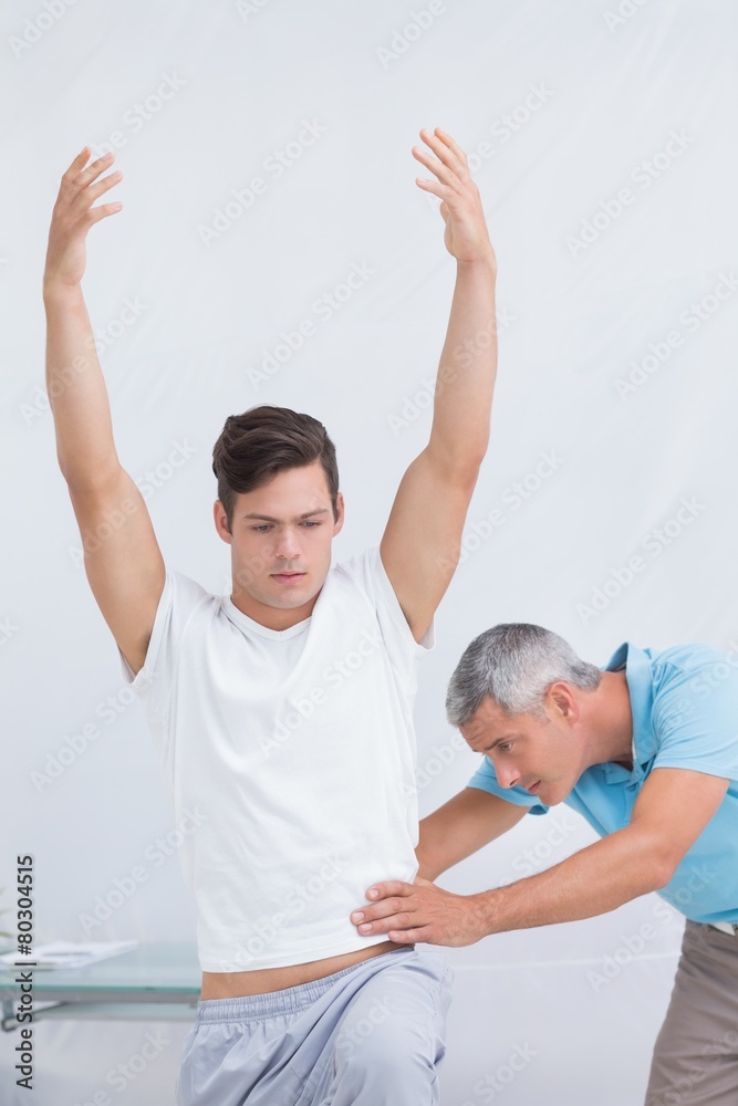 Fototapeta premium Doctor examining his patient back