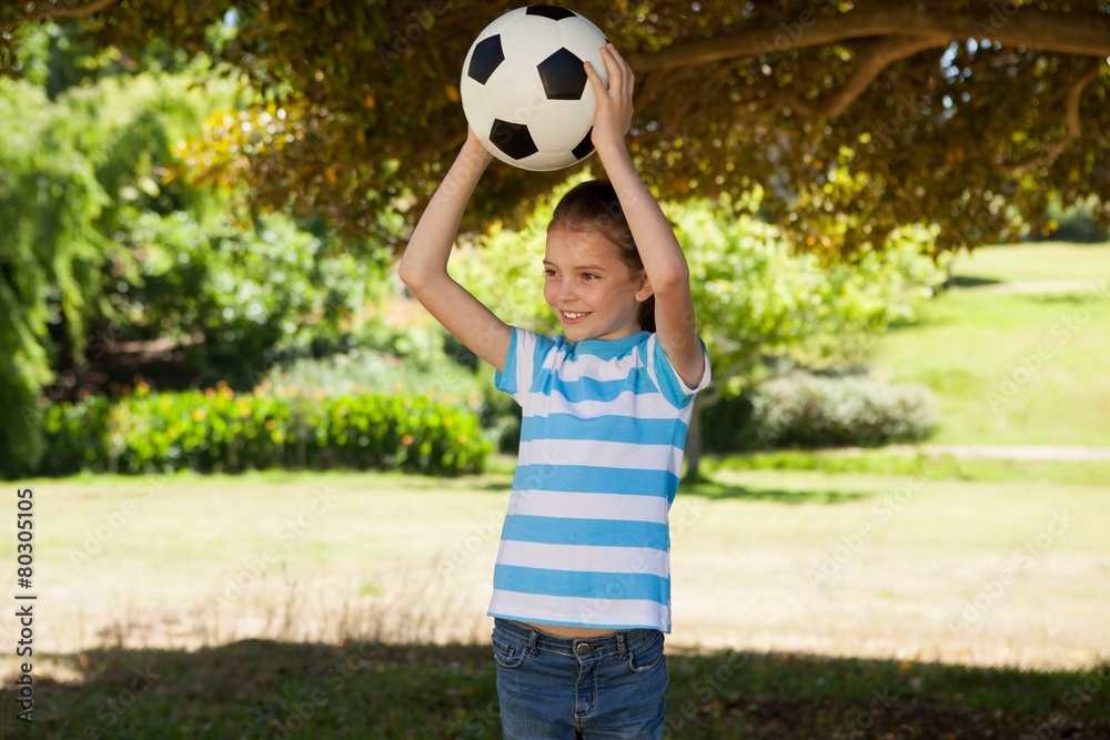 Cute little girl holding ball