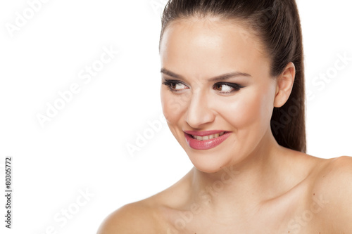 smiling seductive young woman looking aside