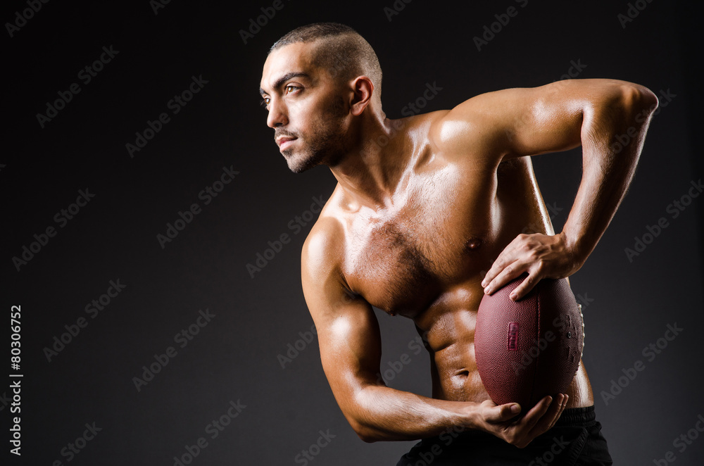 Fototapeta premium Muscular football player with ball