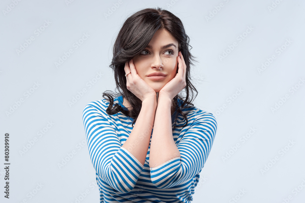 Studio portrait of a young woman. Isolated grey background. Thou Studio portrait of a young woman. Isolated grey background. Thou