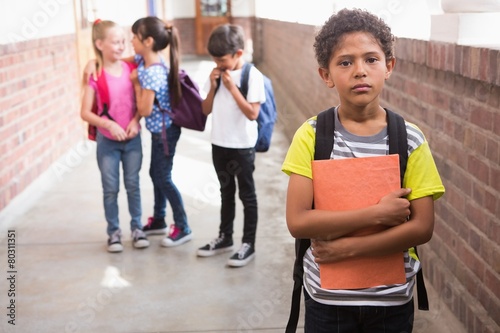 Pupils friends teasing a pupil alone photo