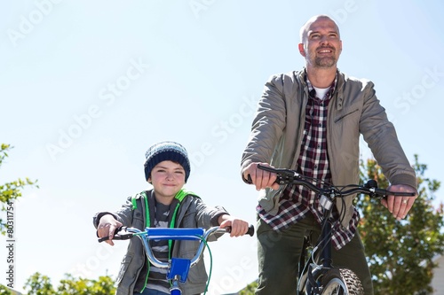 Happy father on a bike with his son