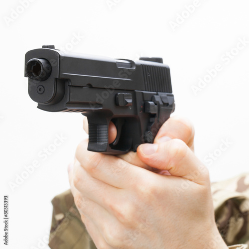 Man in black mask holding handgun