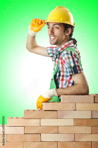 Builder with hard hat on white