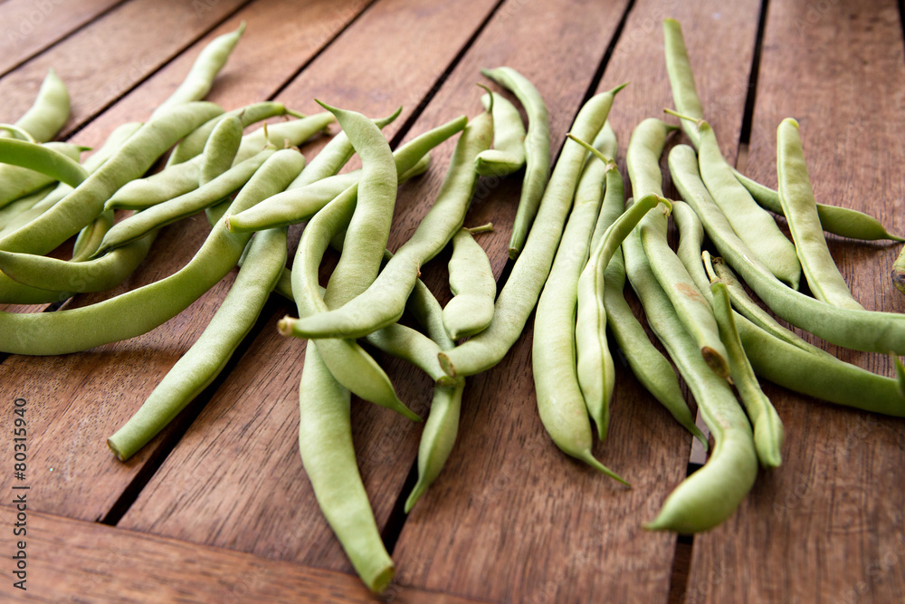 green string beans on wooden table green string beans on wooden table