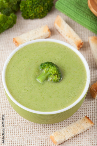 Healthy vegetarian broccoli green cream soup with croutons