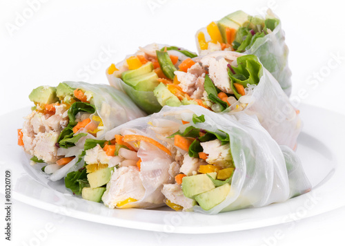 chicken and vegetables spring rolls over white background