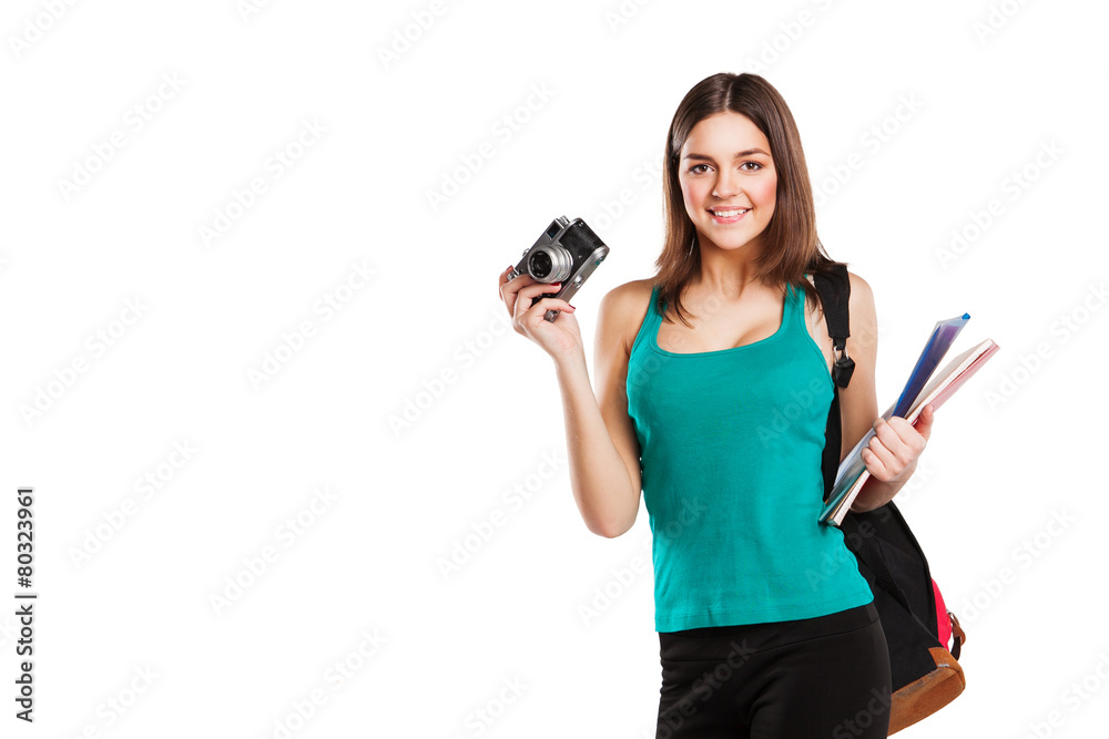 Beautiful young female student posing with notebooks and camera Beautiful young female student posing with notebooks and camera
