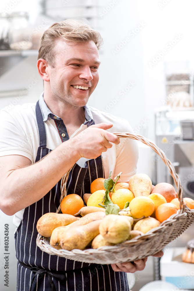Fototapeta premium Man with basket full of fruits