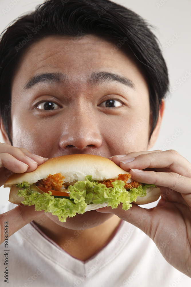 man eating burger on the white background man eating burger on the white background