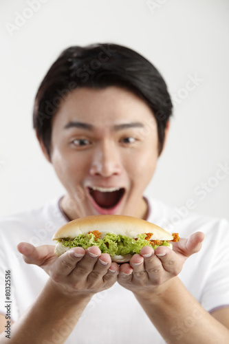 man eating burger on the white background