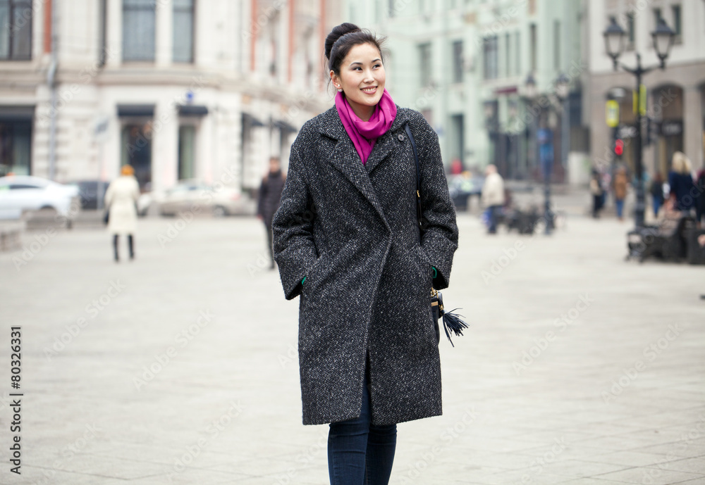 Obraz premium Young beautiful asian woman in stylish gray coat