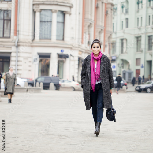 Young beautiful asian woman in stylish gray coat © Andrey_Arkusha