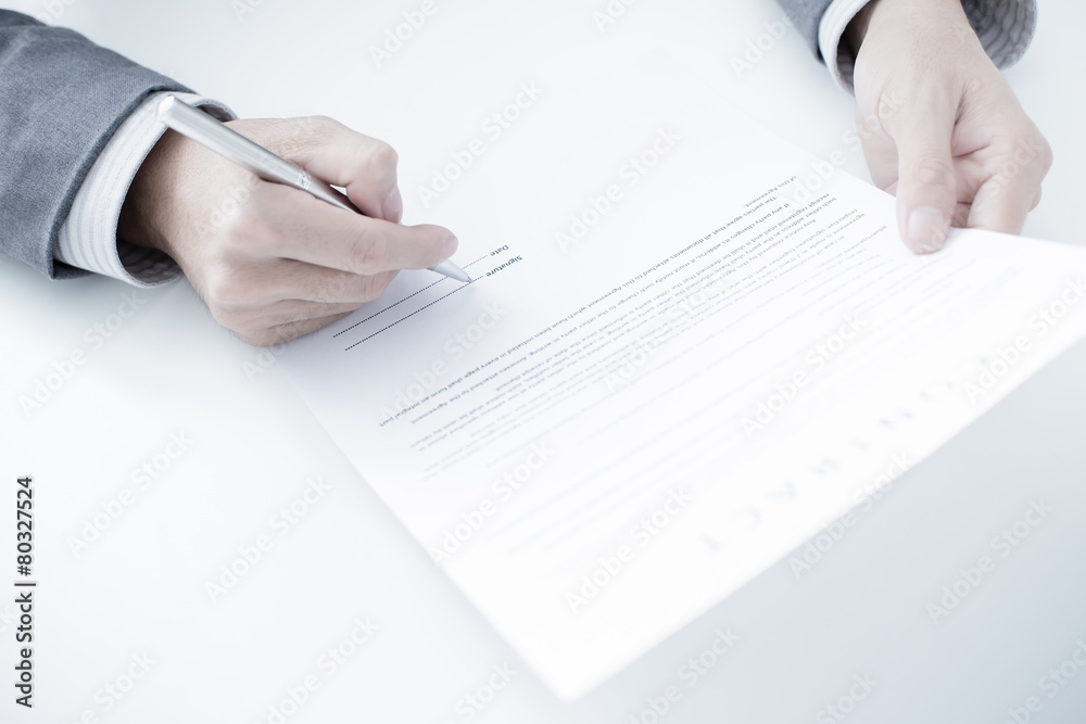Business man signing a contract Business man signing a contract