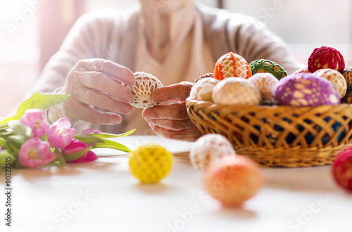 Wall Mural Senior woman with easter eggs