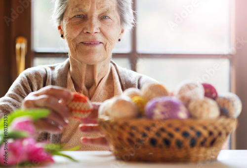 Senior woman with easter eggs