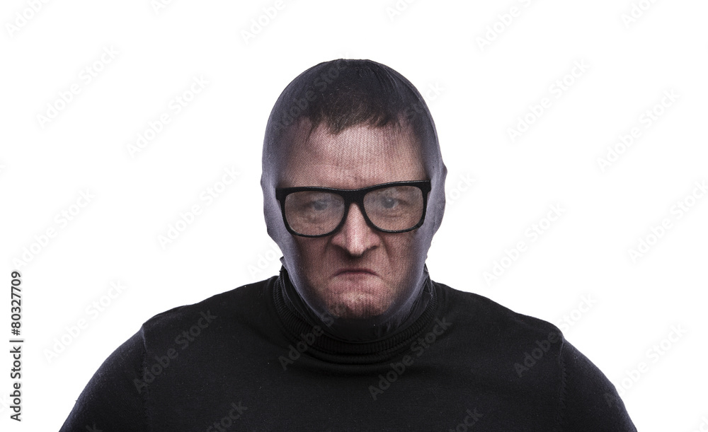 Thief in balaclava making funny faces, dressed in black.