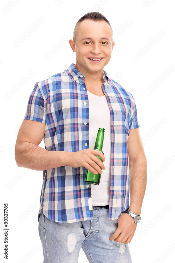 Relaxed young man holding a bottle of beer Relaxed young man holding a bottle of beer