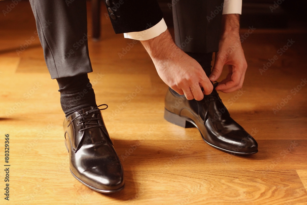 groom geting his wedding shoes on groom geting his wedding shoes on