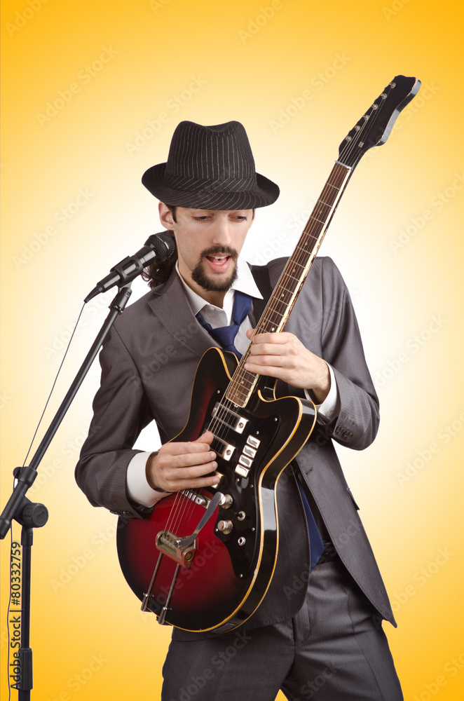 Businessman playing the guitar on white Businessman playing the guitar on white