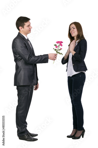 Young man gives a branch of flowers to beautiful lady