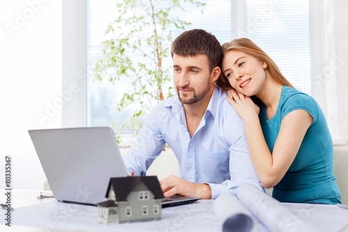 Accountancy. Young couple paying with credit card for online