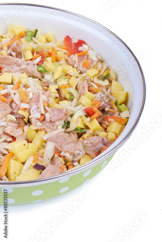 Raw meat with vegetables in a pan, stew
