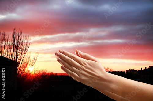 Human hands on sky background