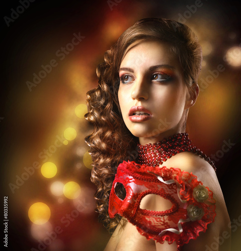 Beautiful girl with masquer...