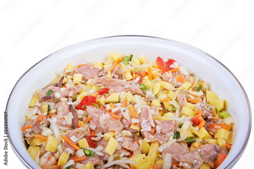 Raw meat with vegetables in a pan, stew Raw meat with vegetables in a pan, stew