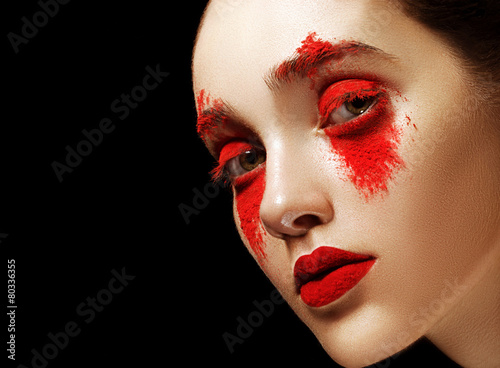 Face art makeup. Woman in red powder