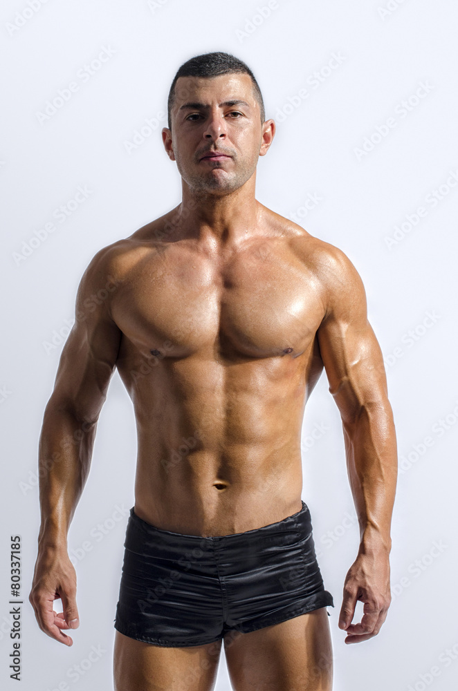 Strong bodybuilder with six pac, shoulders,biceps, triceps,chest