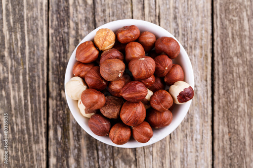 Hazelnuts on a white plate.