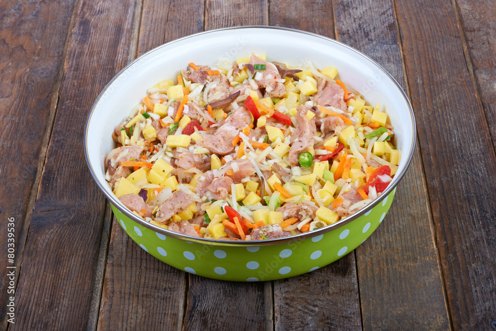 Raw meat with vegetables in a pan, stew Raw meat with vegetables in a pan, stew