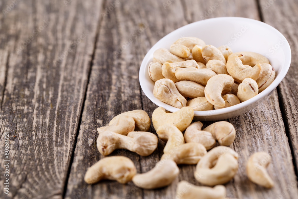 Brazil nuts on a spoon on wooden background. Brazil nuts on a spoon on wooden background.