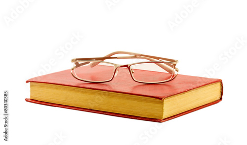 Glasses and red book isolated on white background