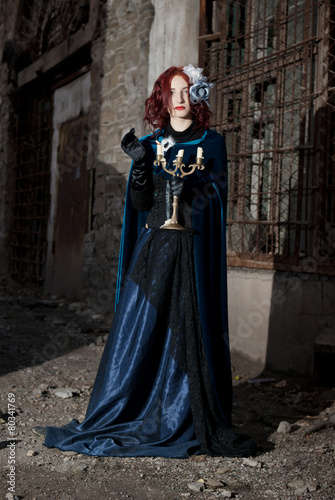 Gothic redhead woman walking with candle © FlexDreams