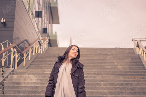 Young beautiful girl posing in the city streets