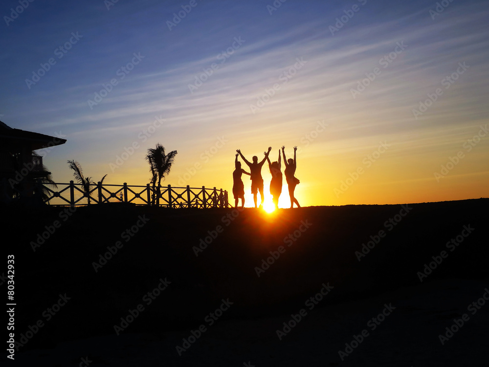silhouette of friends jumping in sunset at beach silhouette of friends jumping in sunset at beach