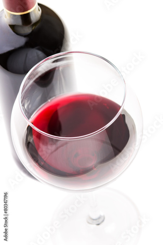 Red wine in glass with bottle