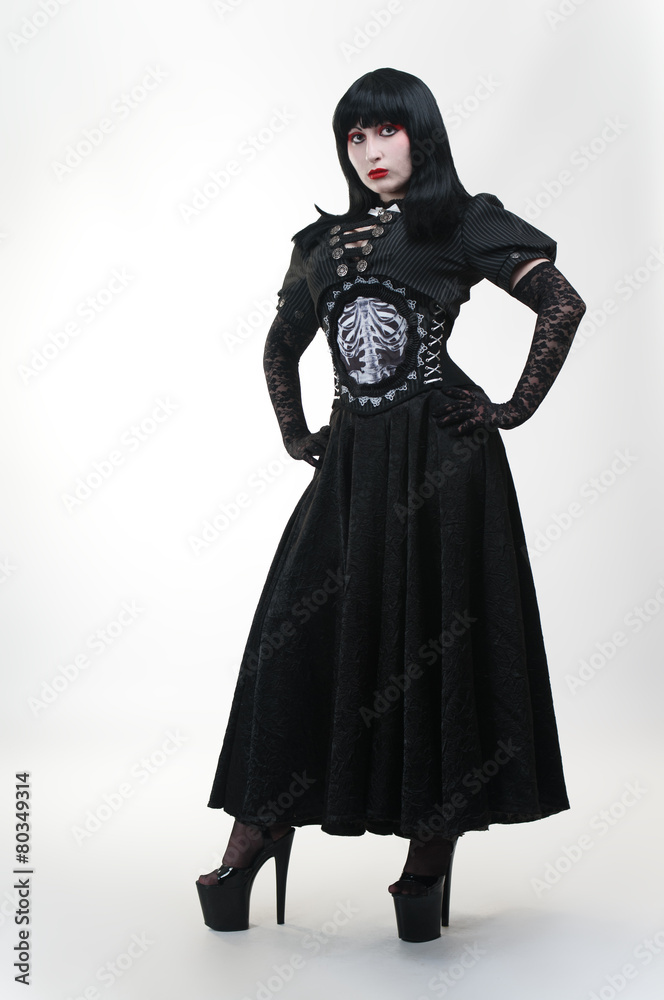 Gothic vampire girl in black dress on white background Gothic vampire girl in black dress on white background