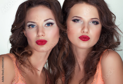 Two pretty womans with red lips