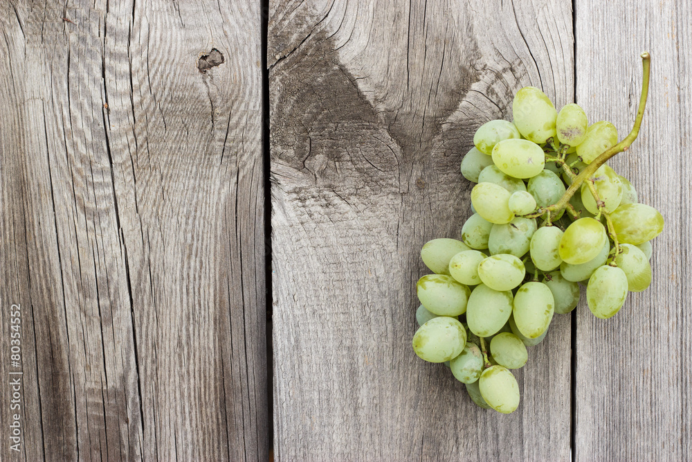 bunch of green grapes on wooden background bunch of green grapes on wooden background