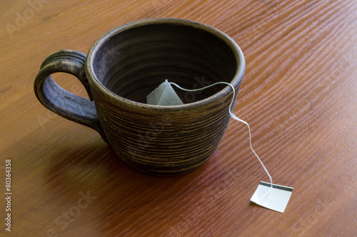 Сlay cup with teabag.