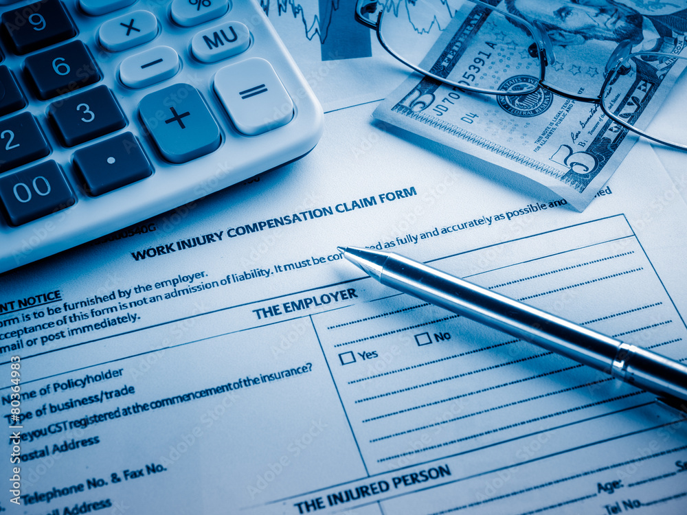 work injury compensation claim form on desk. work injury compensation claim form on desk.