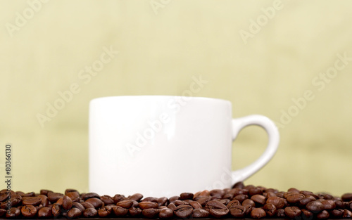 white coffee cup and coffee beans