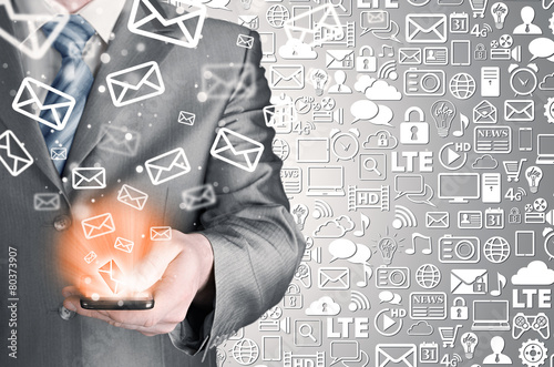 Photos Business man holding smart phone and sending emails