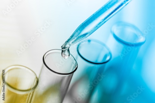 Tube. pipette and test tube on blue background
