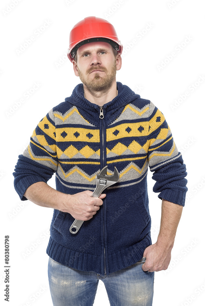 Builder in a helmet with wrench. Builder in a helmet with wrench.